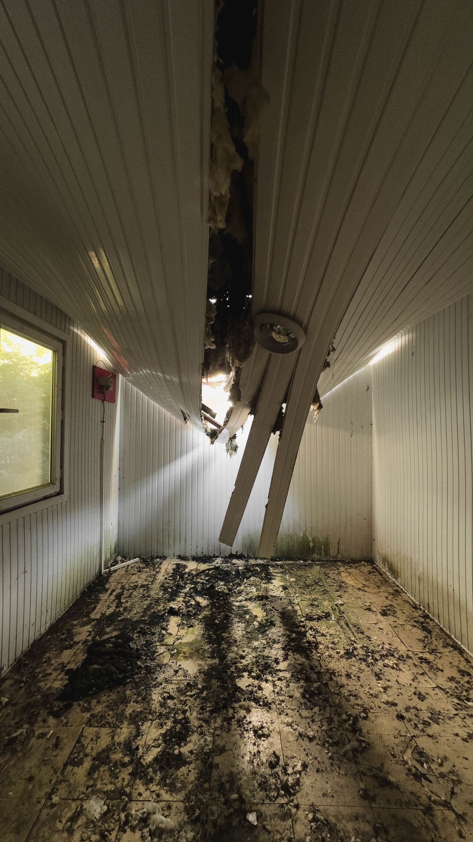 Ceiling panels collapsed into a room after a water leak